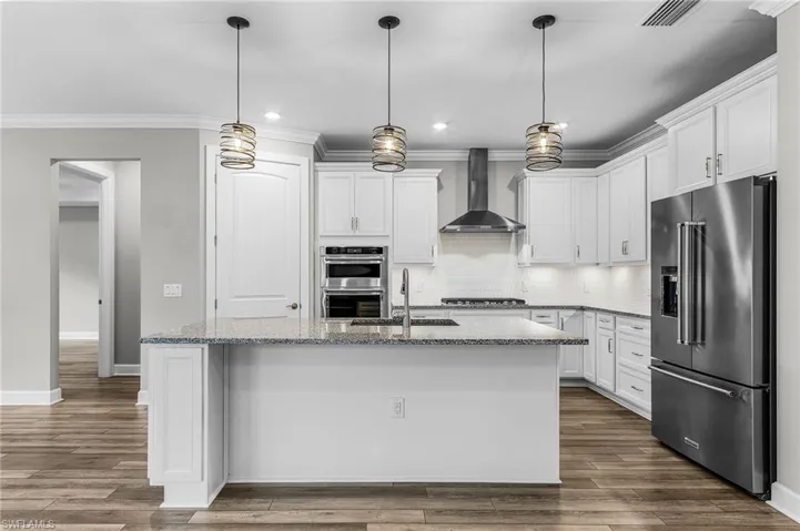Unfurnished bedroom featuring ornamental molding, light wood-style flooring, recessed lighting, a ceiling fan, and a raised ceiling