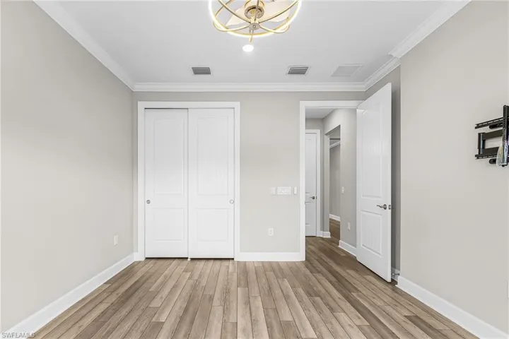 Kitchen with decorative light fixtures, light stone countertops, ceiling fan, white cabinets, and open floor plan