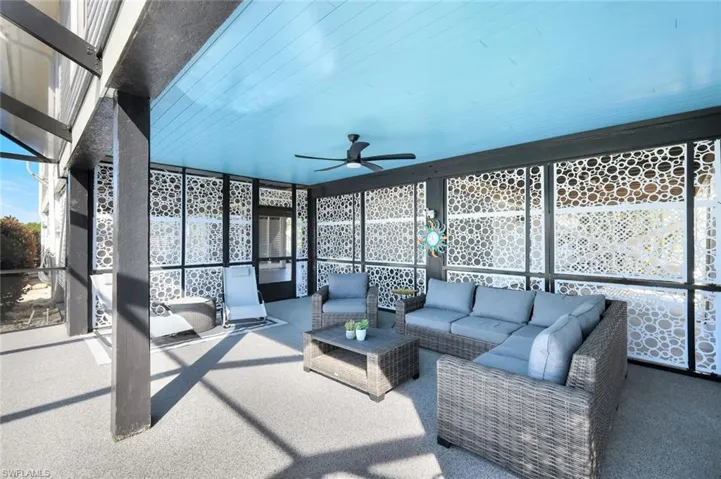 Sunroom / solarium with ceiling fan, healthy amount of natural light, and a patio