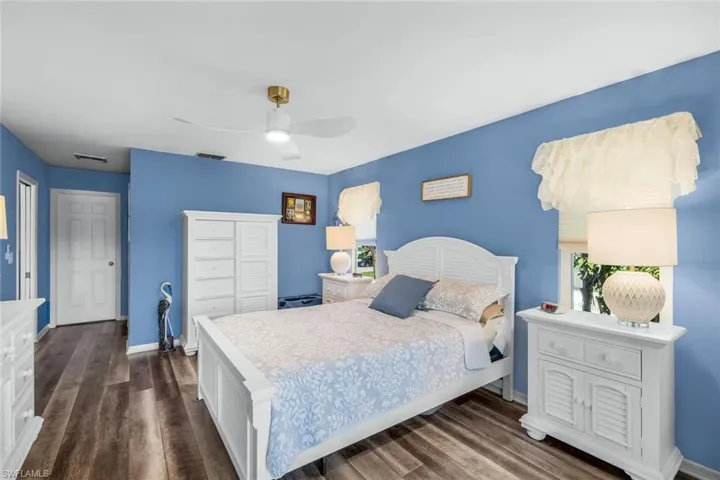 Bedroom with dark wood-type flooring and ceiling fan