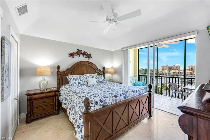 Primary bedroom fits king size bed and has access to screened balcony, ensuite bathroom & walk-in closet.