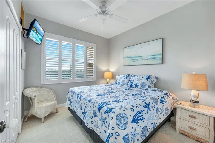 Guest bedroom with room for king size bed with stylish plantation shutters.
