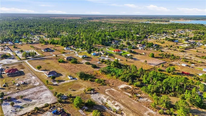 Aerial view of property's location featuring a forest