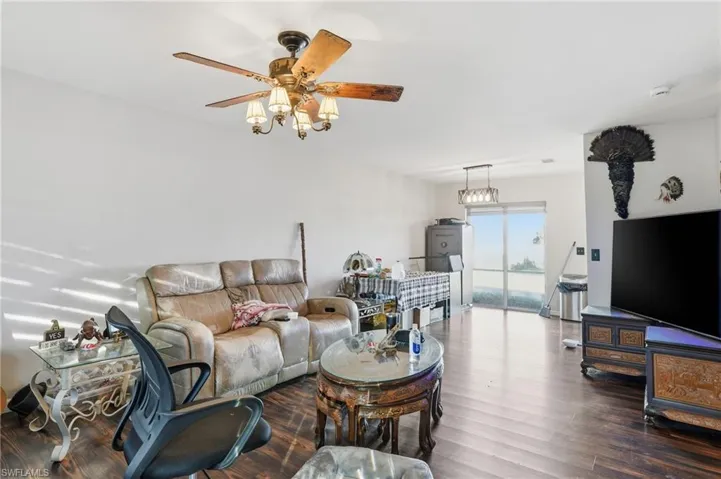 Living area featuring wood finished floors and a ceiling fan