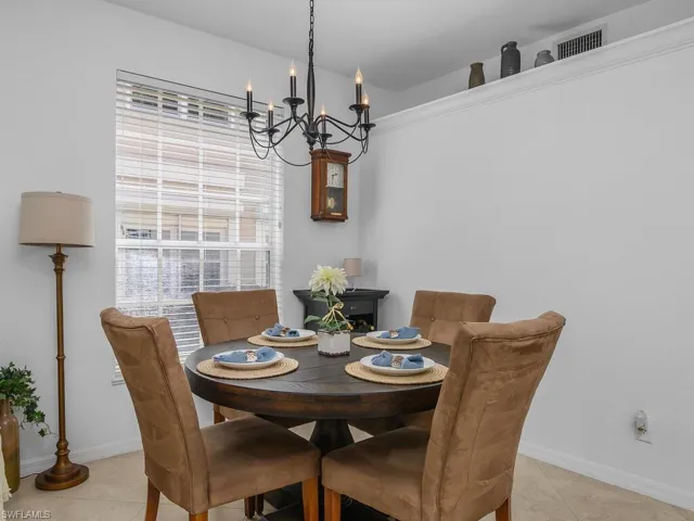 Dining area with hanging lights and light tile flooring