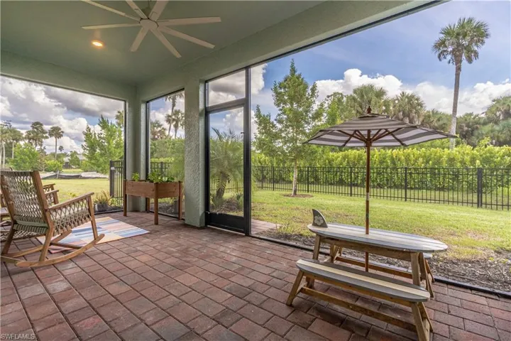 Unfurnished sunroom featuring ceiling fan
