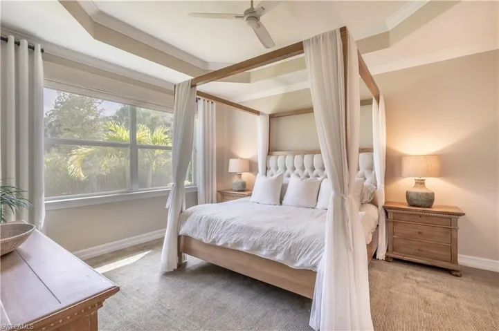 Bedroom featuring crown molding, light colored carpet, and ceiling fan