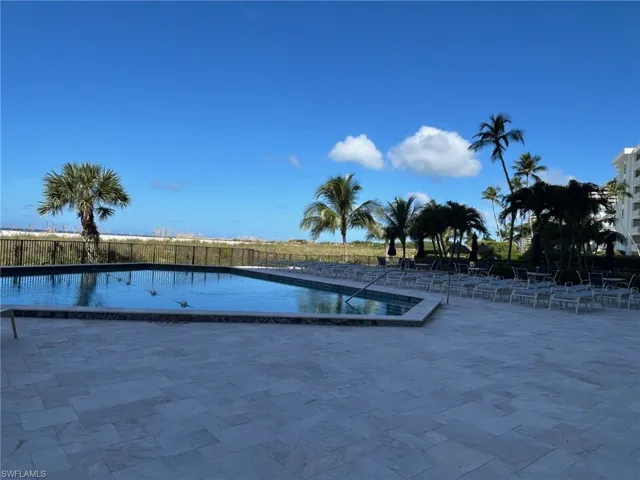 Community pool with a patio