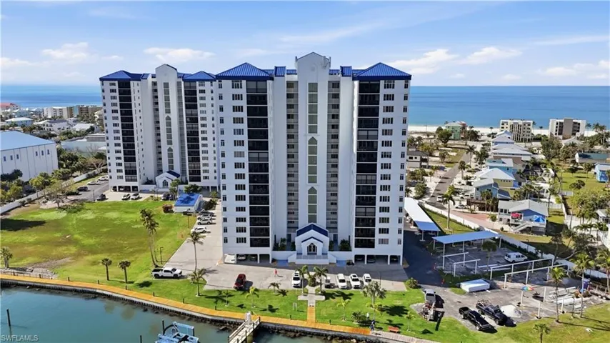 Aerial view of a large body of water and apartment complex / building - Virtually Edited Image