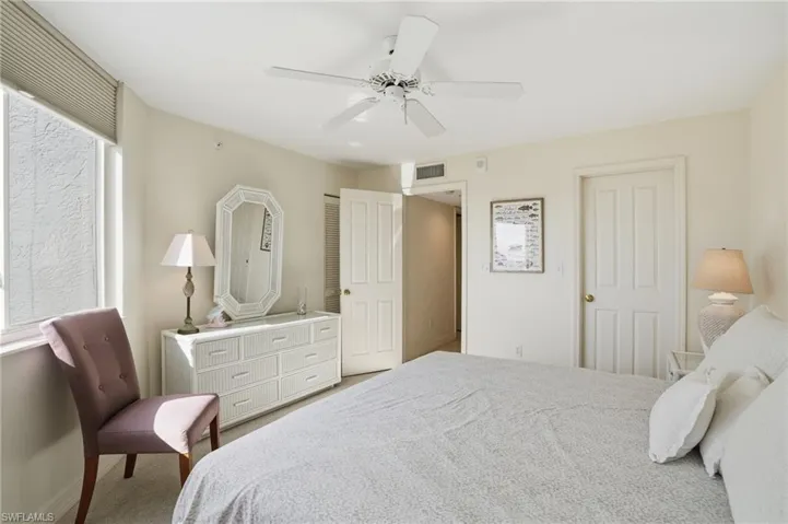 Bedroom with light colored carpet and ceiling fan - Virtually Edited Image
