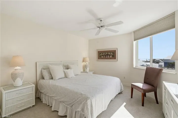 Bedroom featuring ceiling fan and light carpet - Virtually Edited Image