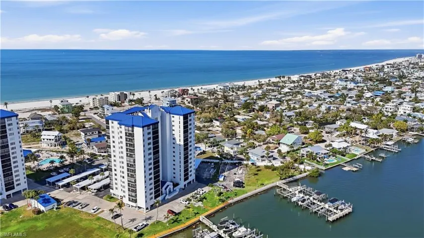 Bird's eye view of expansive coastline and apartment complex / building - Virtually Edited Image