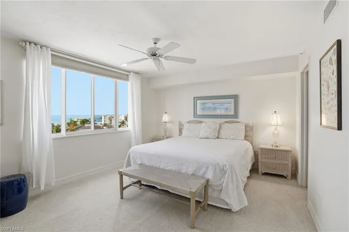 Bedroom with light colored carpet and a ceiling fan - Virtually Edited Image