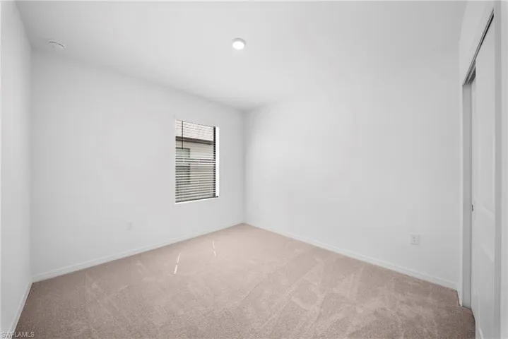 Unfurnished bedroom with carpet flooring and a closet