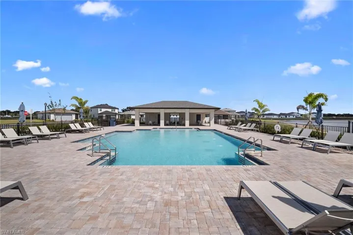 Community pool featuring a patio area and a residential view