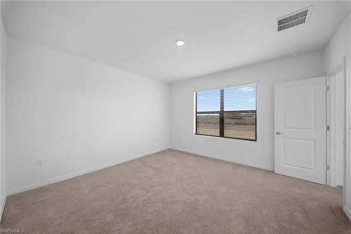 Unfurnished room featuring carpet and baseboards
