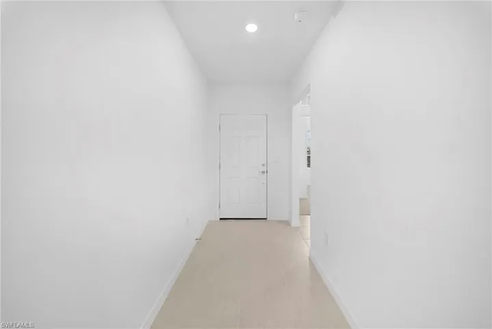 Corridor featuring baseboards
