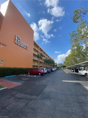 View of parking featuring a carport
