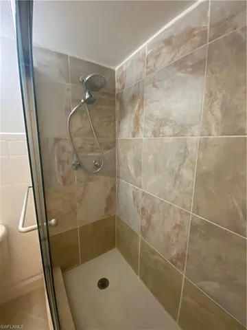 Bathroom with tile walls and walk in shower