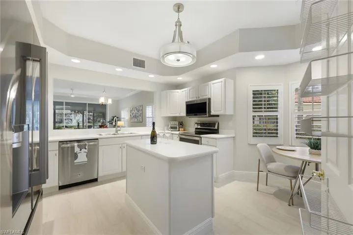 Newer kitchen appliances, kitchen sink, faucet, garbage disposal, and lighting.