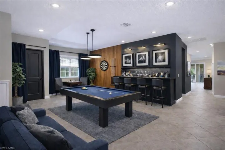 Rec room with a dry bar, pool table, a textured ceiling, and recessed lighting