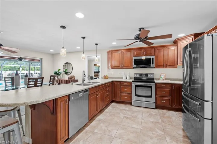 Well equipped kitchen with stainless steel appliances and fan for your comfort