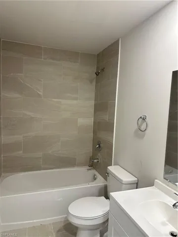 Bathroom featuring vanity and washtub / shower combination