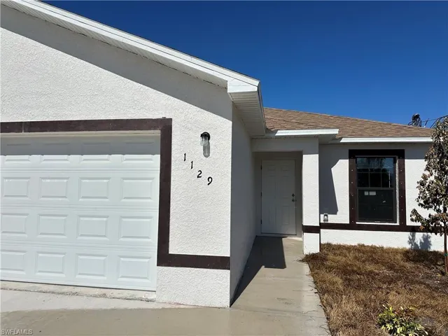 Entrance to property with stucco siding