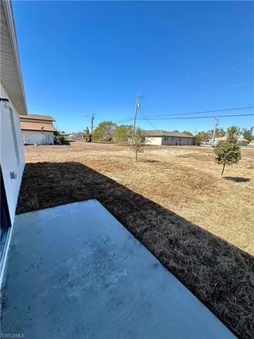 View of grassy yard with a patio