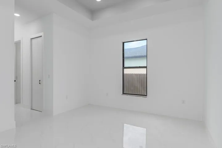 Unfurnished room with marble tiled flooring and recessed lighting