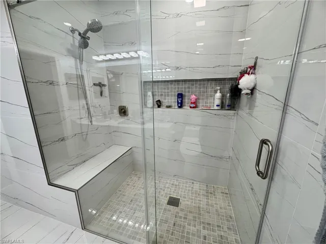 Full bathroom featuring a shower stall
