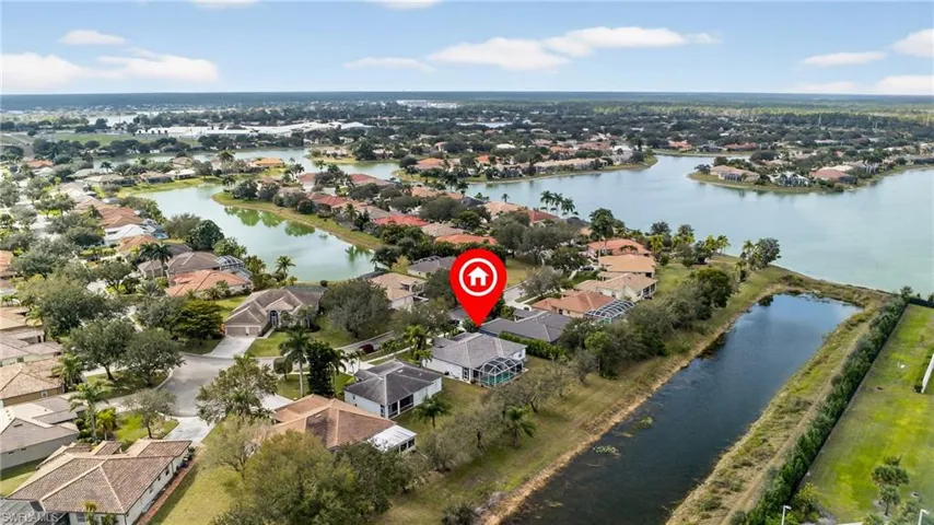 Aerial overview of property's location with a large body of water and nearby suburban area
