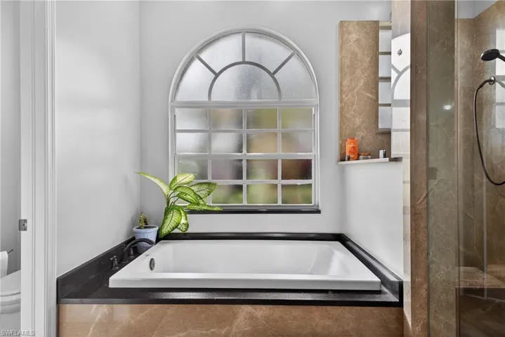 Full bath featuring a garden tub and walk in shower