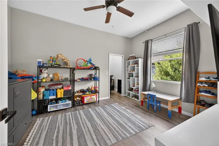 Rec room with light wood-type flooring and a ceiling fan