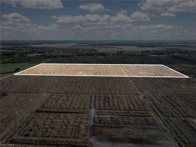 Aerial view of sparsely populated area with abundant farmland and property parcel outlined