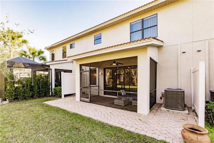 Rear view of property with a lanai, ceiling fan, central AC, and a patio