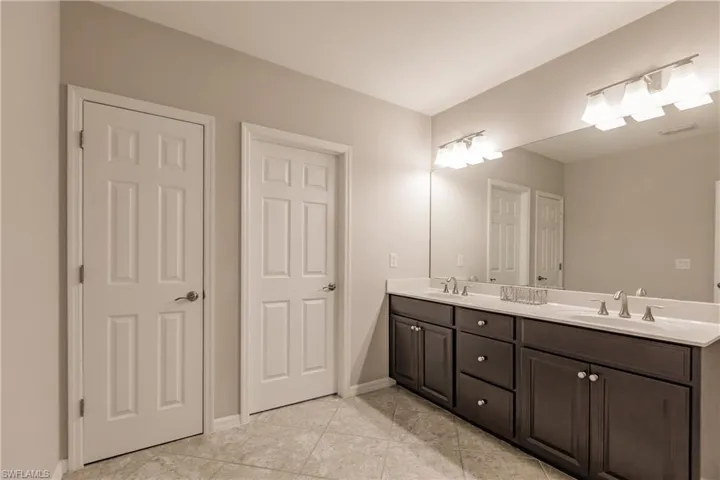 Bathroom with vanity and tile patterned flooring