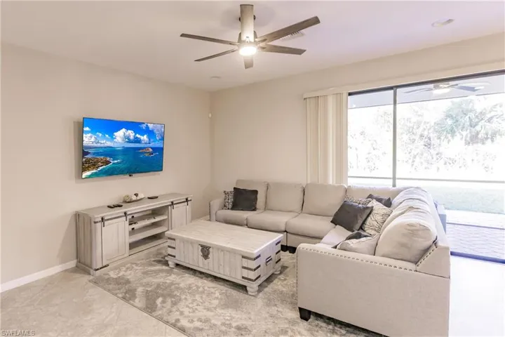 Living room featuring ceiling fan and light tile patterned flooring