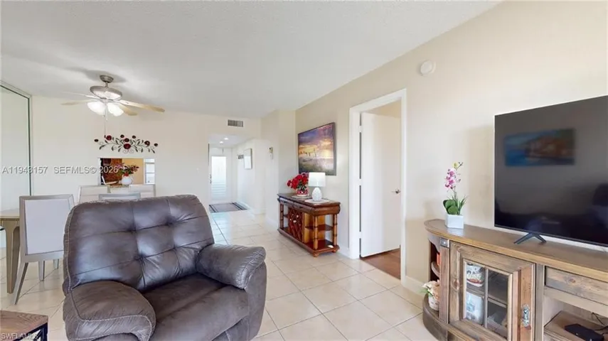 Living area featuring neutral-toned walls and tile flooring