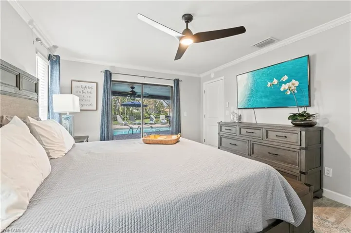 Primary Bedroom featuring access to outside, ceiling fan, and ornamental molding