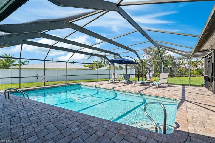 View of pool with a lanai, a yard, and a patio