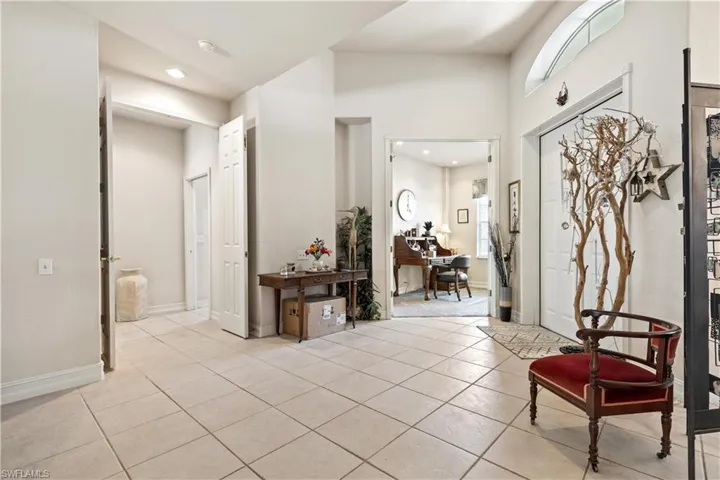 Tiled foyer entrance with a high ceiling