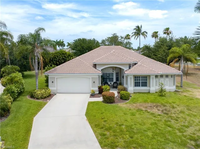 Single story home featuring a garage and a front yard