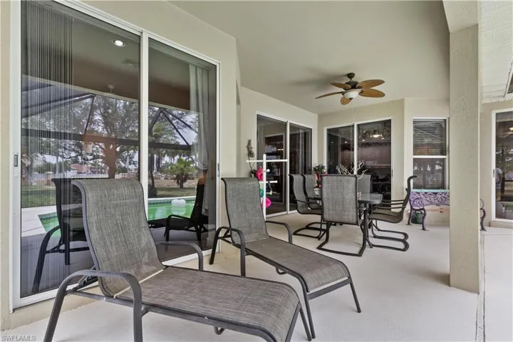 View of patio / terrace with ceiling fan and a pool