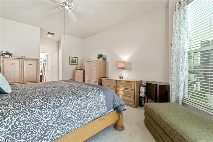 Carpeted bedroom with ceiling fan