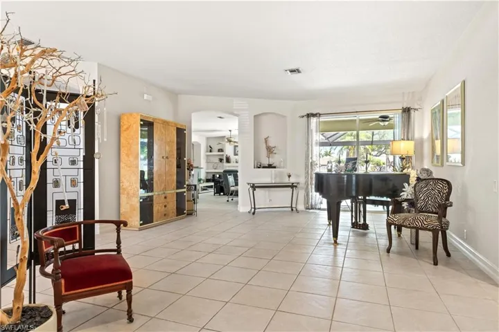 Sitting room featuring ceiling fan and light tile floors