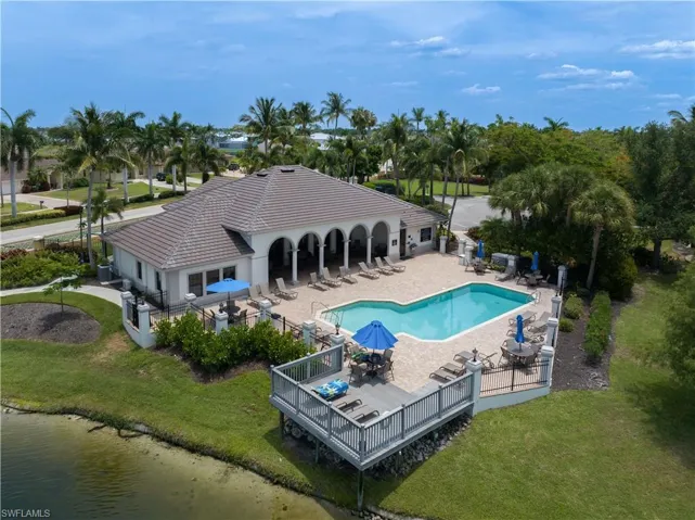View of swimming pool featuring a patio and a yard