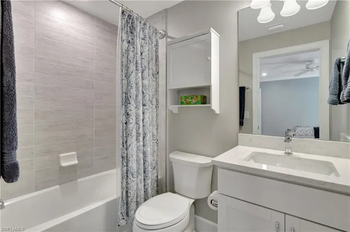 Full bathroom with ceiling fan, toilet, shower / tub combo, and vanity 0ff 3rd bedroom