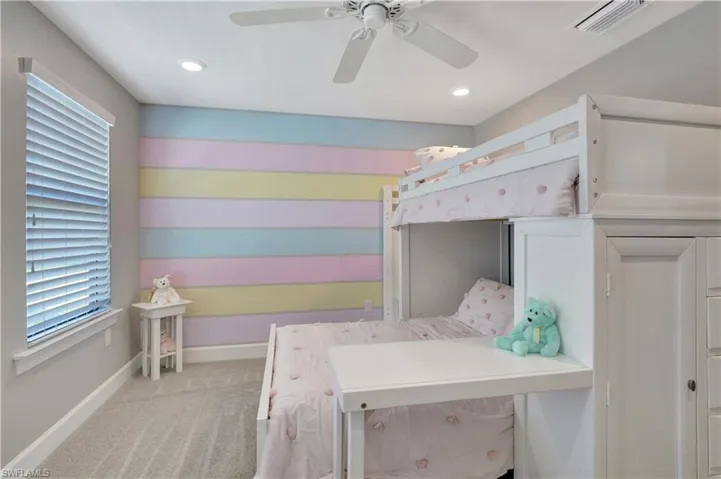 Carpeted bedroom with ceiling fan