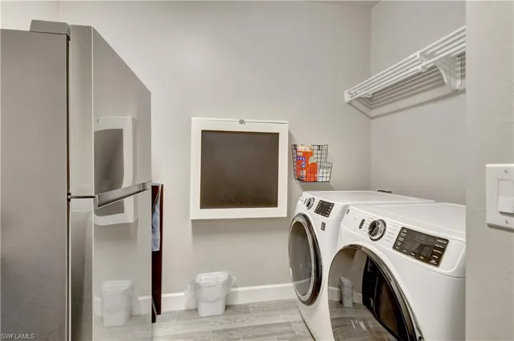 Laundry room featuring light wood-type flooring and washer and clothes dryer